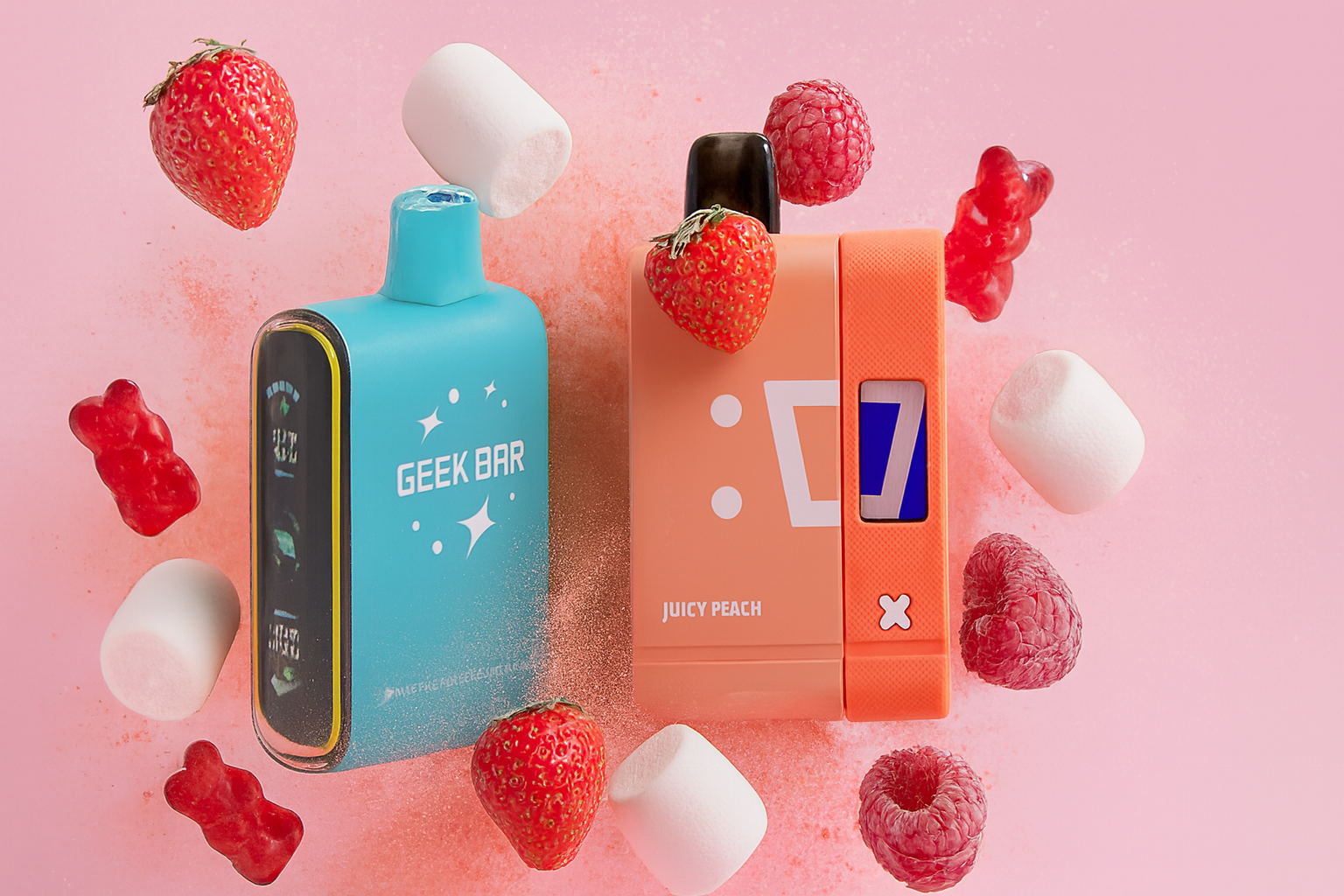 The photo features two colorful vape devices surrounded by fruits and sweets against a playful pink background with a powdery texture. On the left, a sleek blue device labeled “GEEK BAR” includes a display screen, giving it a modern, tech-inspired look. On the right, a bright orange device marked “JUICY PEACH” with a stylized face icon emphasizes a fun, flavor-driven identity. Scattered around them are strawberries, raspberries, marshmallows, and red gummy bears, visually suggesting fruity and candy-like flavor profiles. The composition blends bold design with a sweet, energetic atmosphere, making the scene eye-catching and flavor-focused.